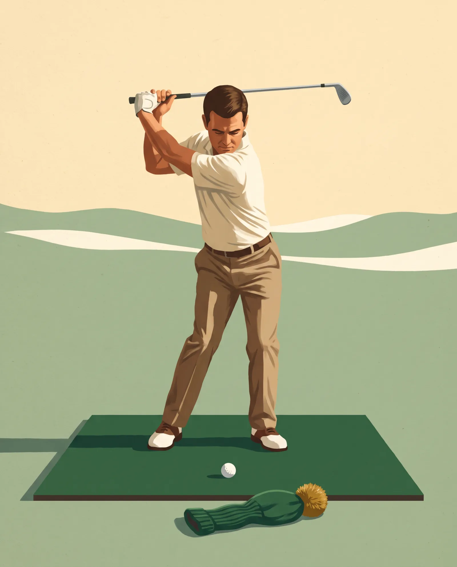 A golfer paused at the top of his backswing, a headcover on the mat beyond the ball